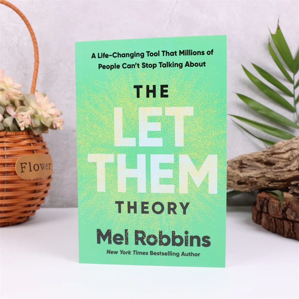 Book titled 'The Let Them Theory' by Mel Robbins on a white surface with decorative elements.