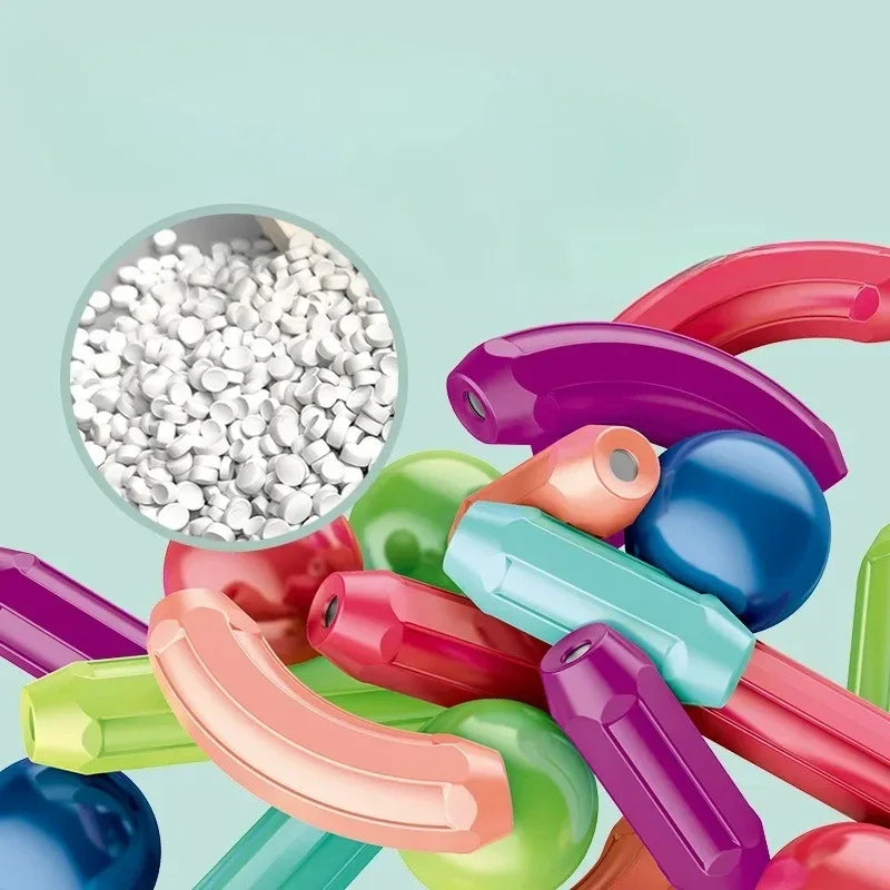 Colorful plastic building blocks with a close-up inset of white plastic pellets on a light blue background.