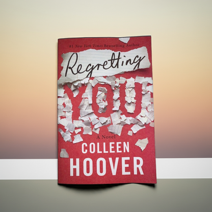 This image features the cover of the novel titled "Regretting You" by Colleen Hoover. The cover design is striking with a bold red background and prominent white text that highlights the title in a dynamic, broken-piece style.