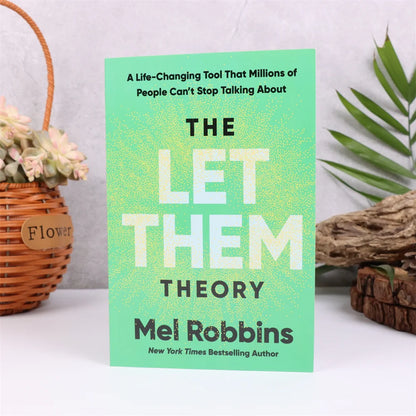Book titled 'The Let Them Theory' by Mel Robbins on a white surface with decorative elements.