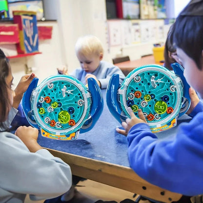 Children playing with educational puzzle round toys at a table in a classroom setting