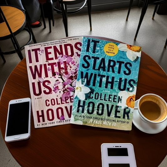 Two books by Colleen Hoover in a coffee shop table with coffee and a cellphone